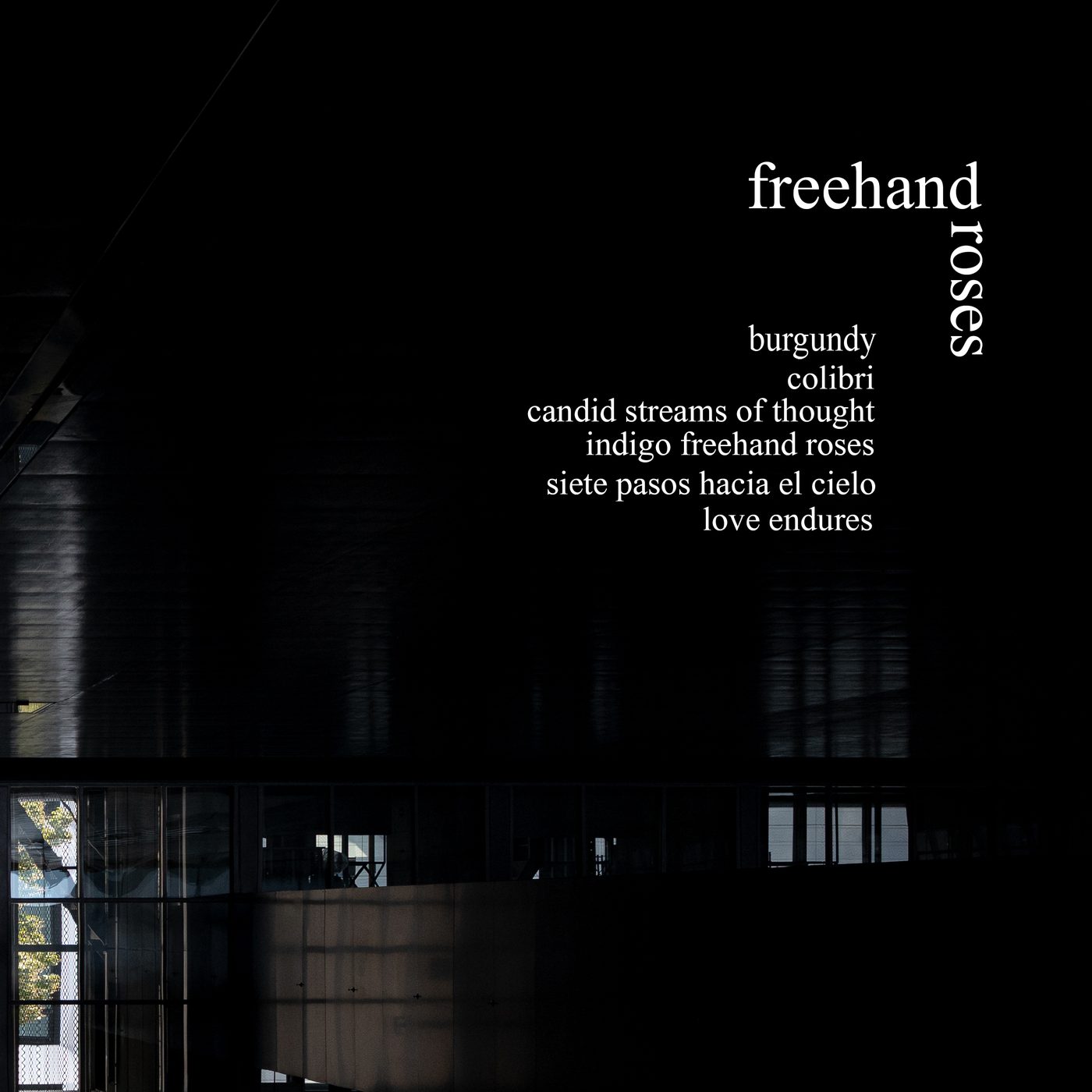 Freehand Roses — cover art: white type over a dark building at night